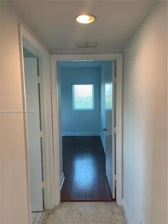 a view of an empty room and wooden floor