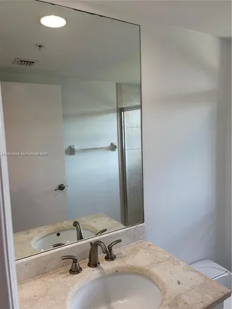 a bathroom with a sink and shower