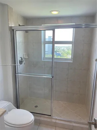 a bathroom with a shower and a toilet