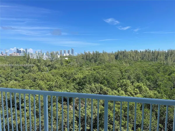 a view of a green space with a mountain in the background