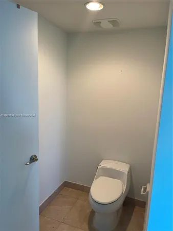 a white toilet sitting in a bathroom