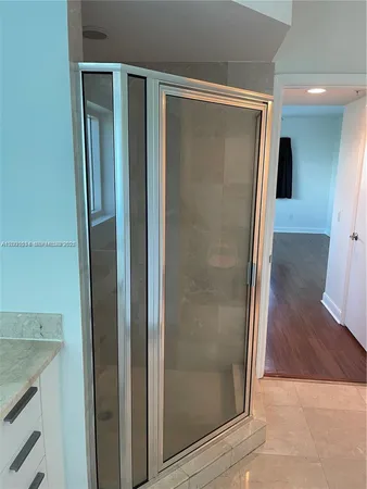 a bathroom with a glass shower door