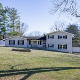 a view of a house with pool and sitting area