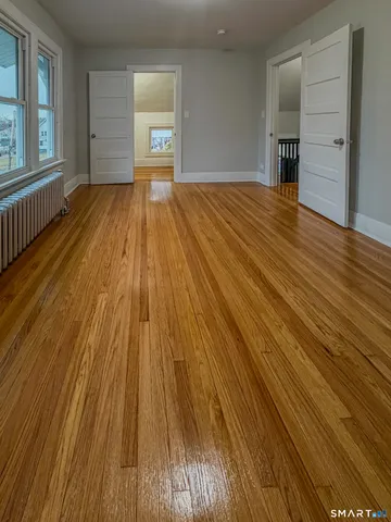 wooden floor in an empty room with a window