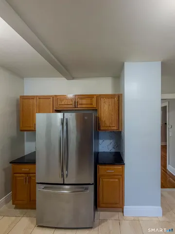 a metallic refrigerator freezer sitting in a kitchen
