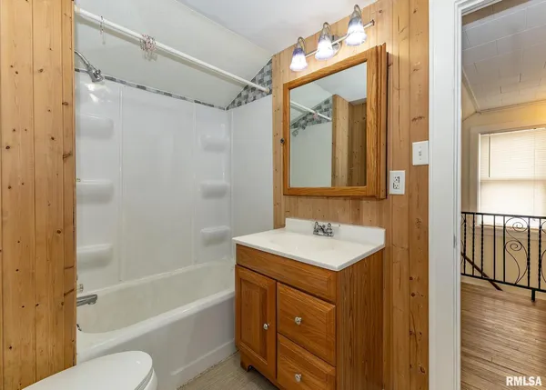 a bathroom with a sink toilet tub and shower