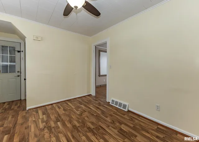 an empty room with a empty space and a ceiling fan