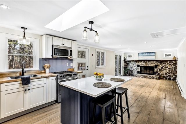 a kitchen with a sink stove and microwave