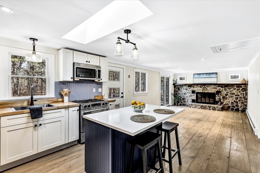 55 Howes Road Wellfleet, MA 02667 - Photo 11 of 33 a kitchen with a sink stove and microwave