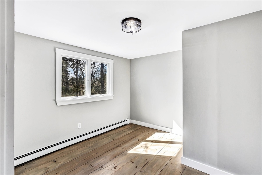 55 Howes Road Wellfleet, MA 02667 - Photo 18 of 33 a view of an empty room with wooden floor and a window