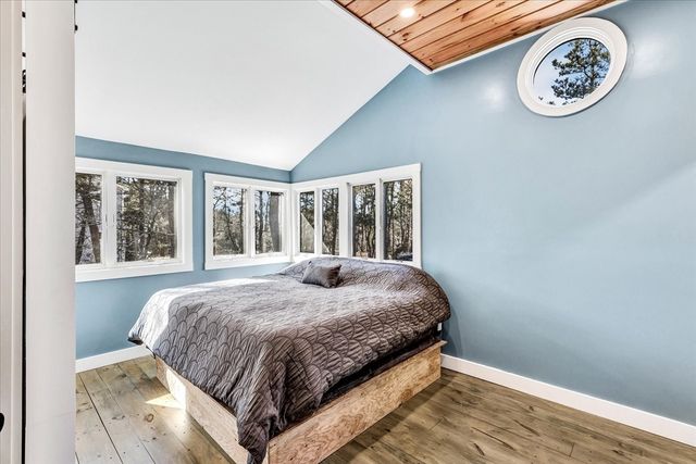 a bedroom with a bed and a large window