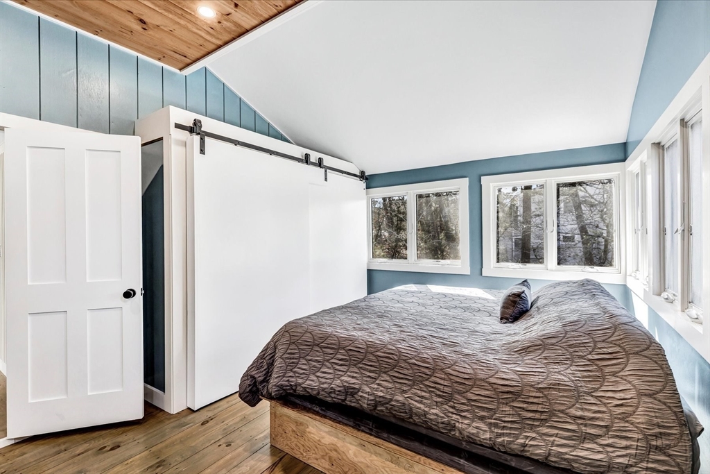 55 Howes Road Wellfleet, MA 02667 - Photo 21 of 33 a bedroom with a bed and a window