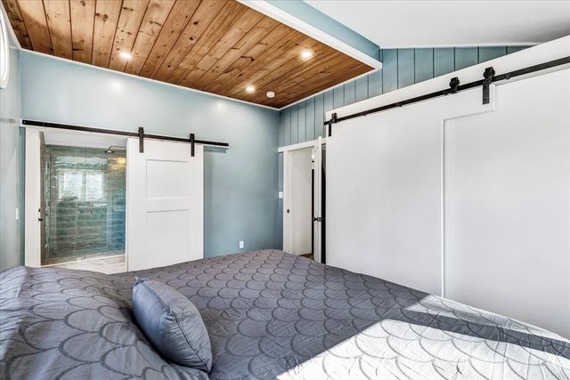 a bedroom with a bed and a mirror