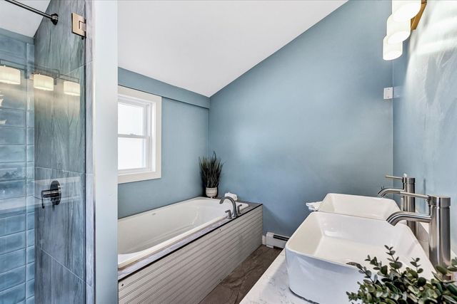 a bathroom with a tub toilet and sink