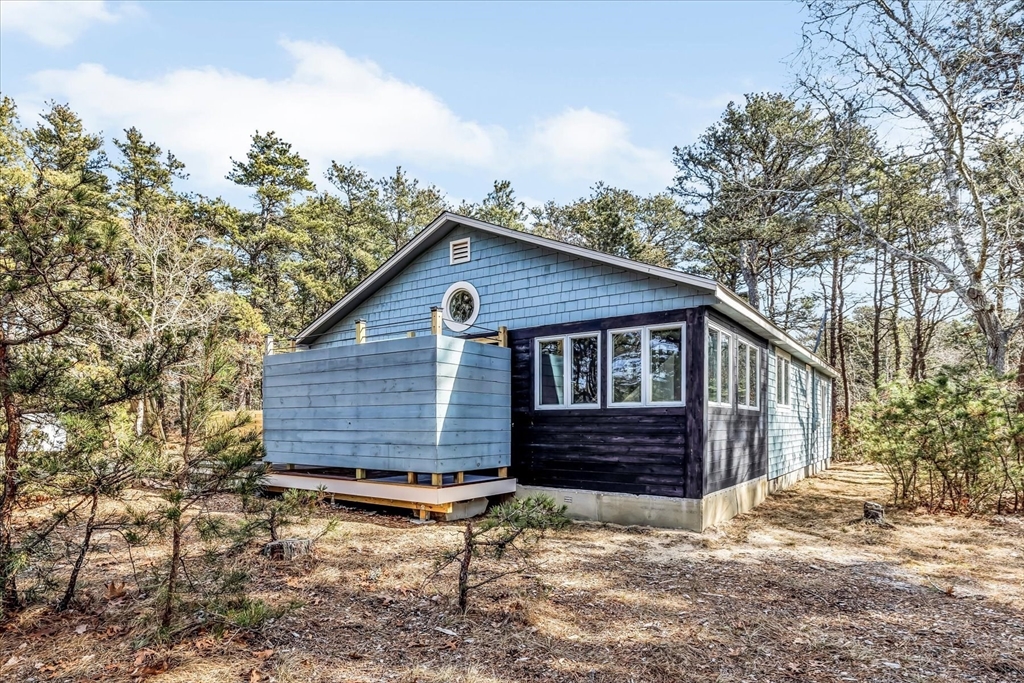 55 Howes Road Wellfleet, MA 02667 - Photo 26 of 33 a view of a house with a yard