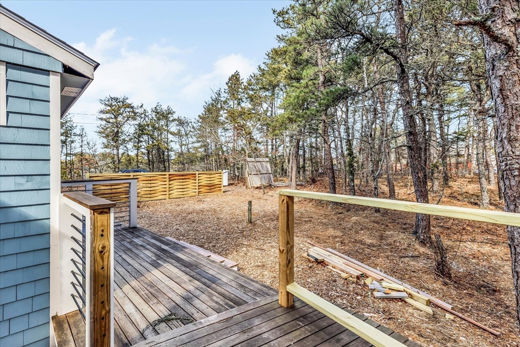 55 Howes Road Wellfleet, MA 02667 - Photo 27 of 33 a view of a yard with wooden fence
