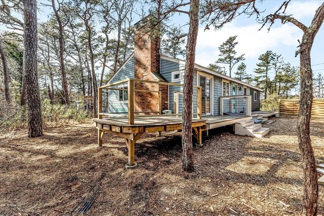 a backyard of a house with barbeque oven table and chairs