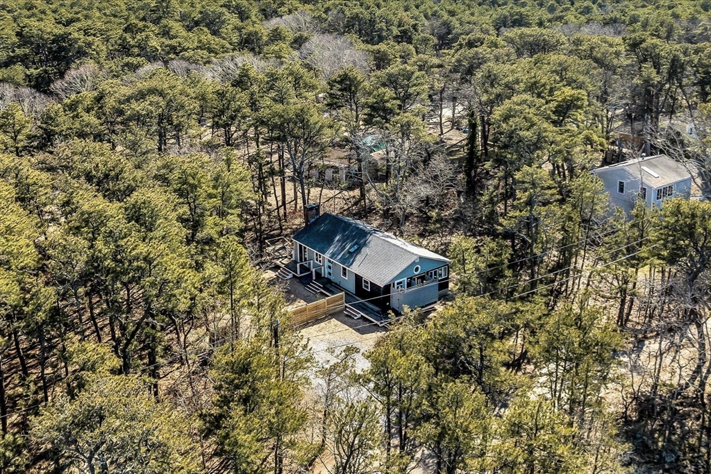 55 Howes Road Wellfleet, MA 02667 - Photo 6 of 33 a backyard of a house with table and chairs