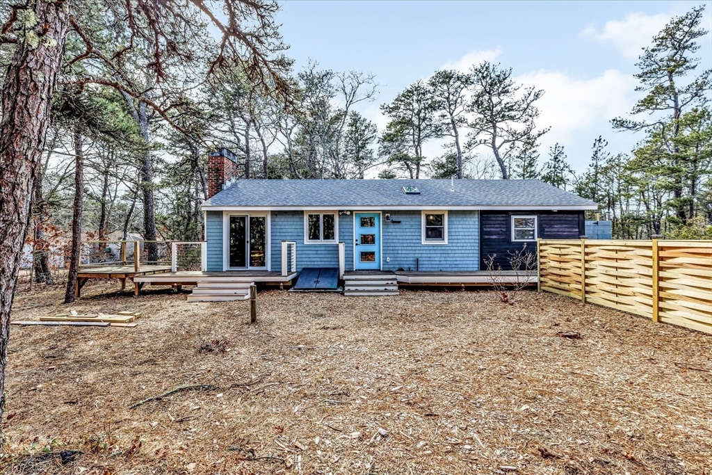 55 Howes Road Wellfleet, MA 02667 - Photo 7 of 33 a view of a house with a yard and sitting area