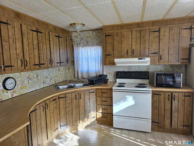 a kitchen with a stove a sink and a refrigerator