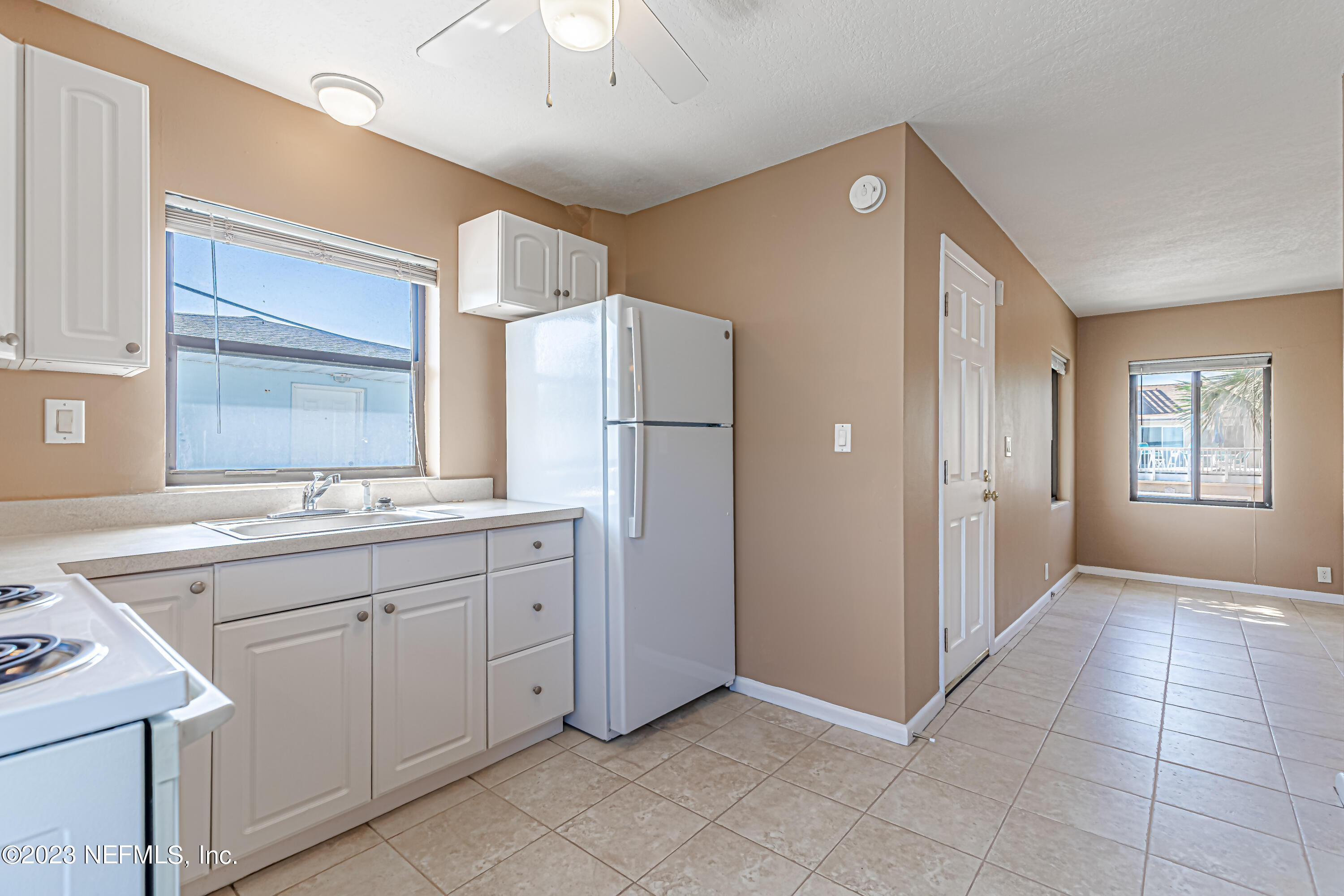 1907 First Street Neptune Beach, FL 32266 - Photo 13 of 29 a kitchen with a sink cabinets and stainless steel appliances