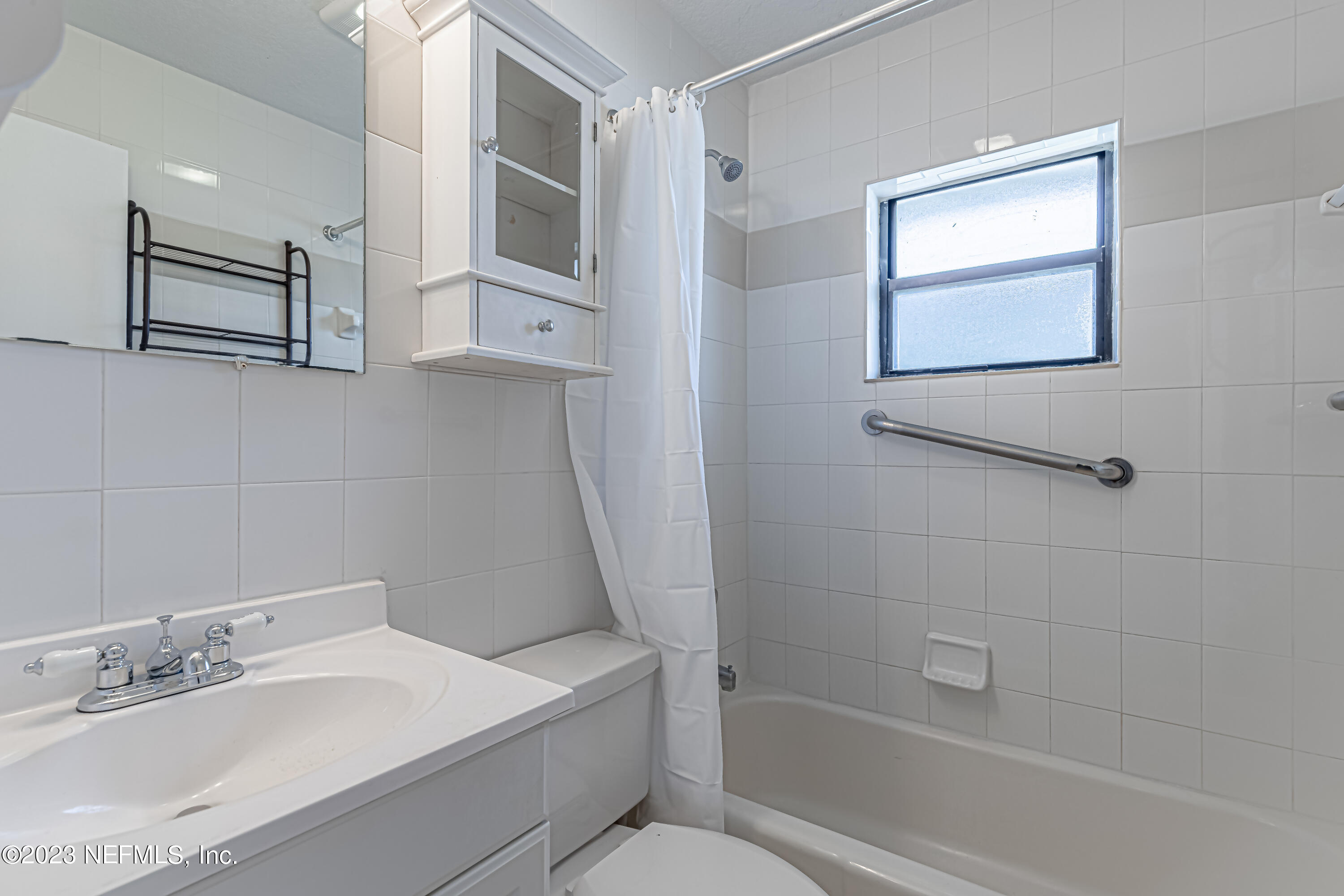 1907 First Street Neptune Beach, FL 32266 - Photo 16 of 29 a bathroom with a sink toilet and shower