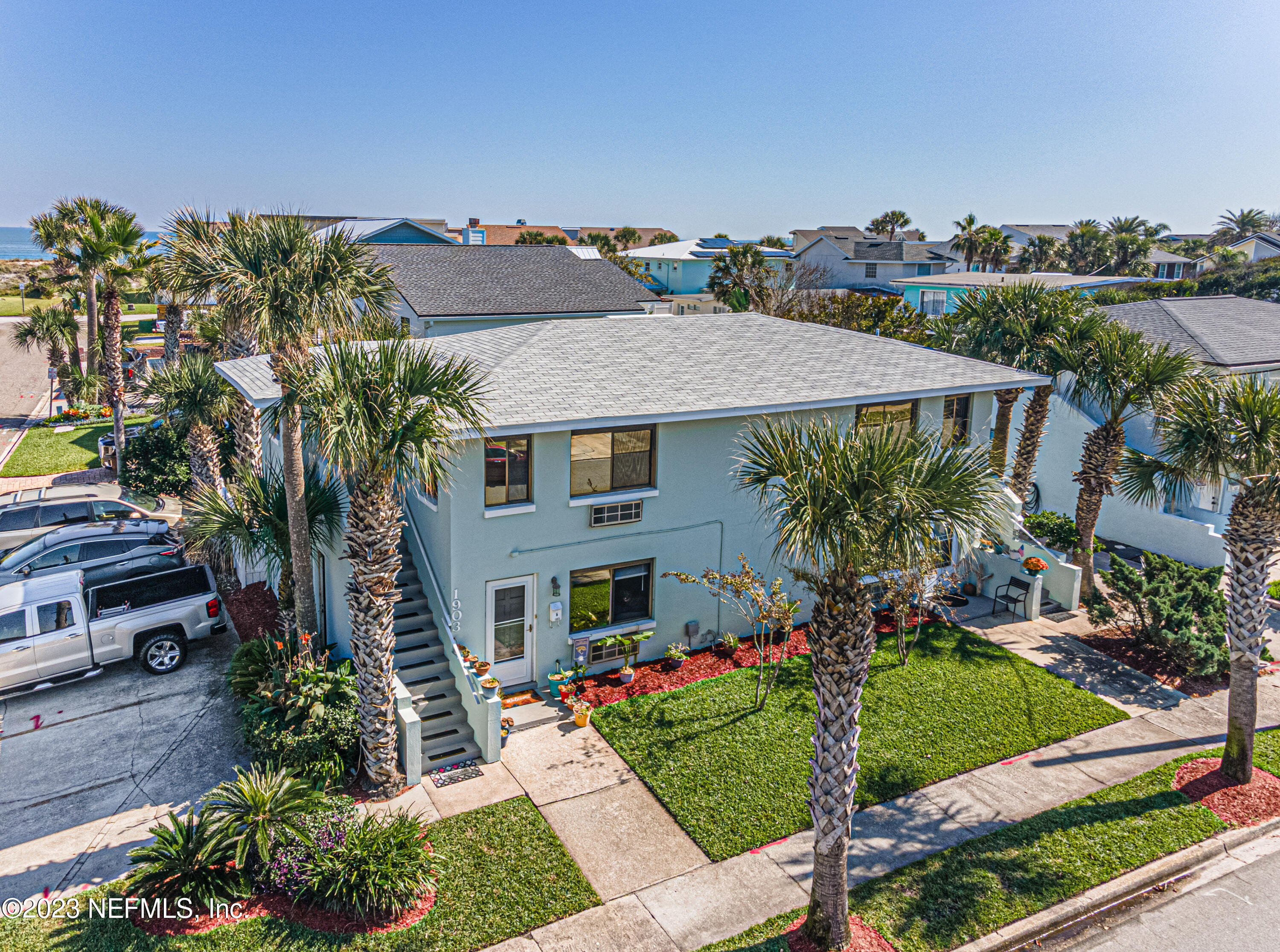 1907 First Street Neptune Beach, FL 32266 - Photo 21 of 29 a front view of a house with a yard and potted plants