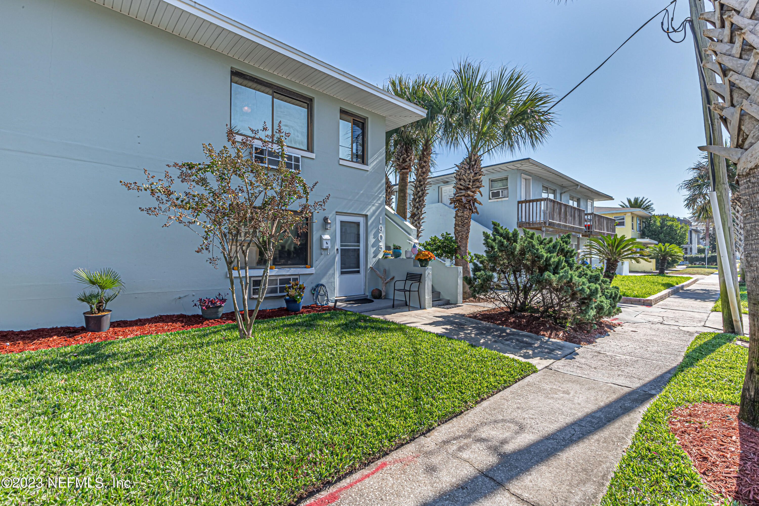 1907 First Street Neptune Beach, FL 32266 - Photo 3 of 29 a front view of house with yard and outdoor seating