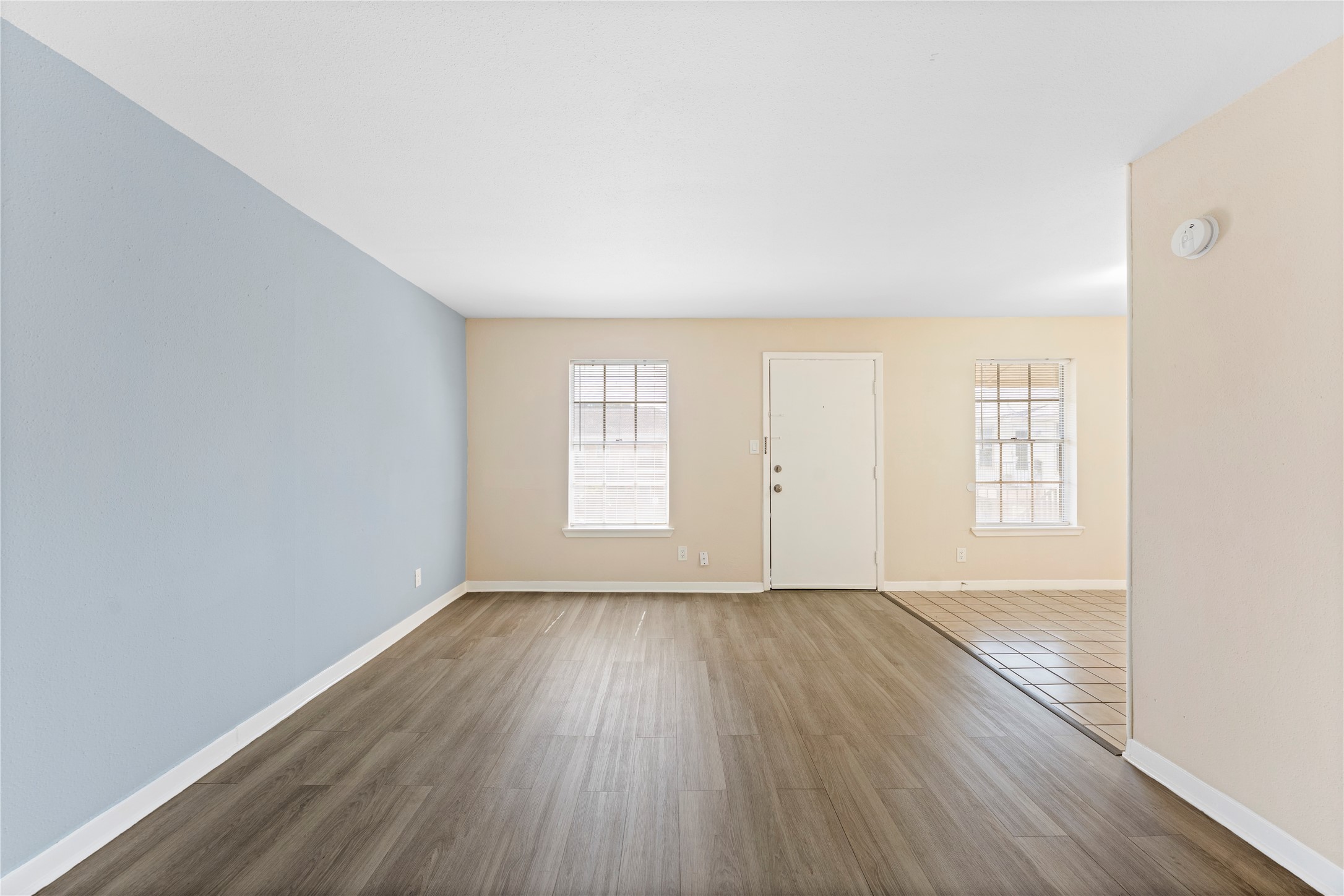 3316 Burke Road, Unit 43 Pasadena, TX 77504 - Photo 3 of 15 an empty room with wooden floor and windows