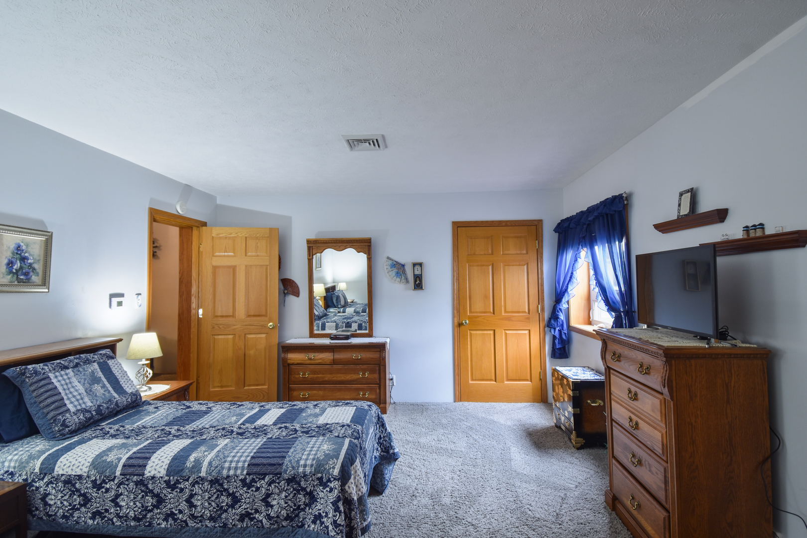 103 South 4th Street Chatsworth, IL 60921 - Photo 41 of 70 a bedroom with a bed and a flat tv screen on a dresser