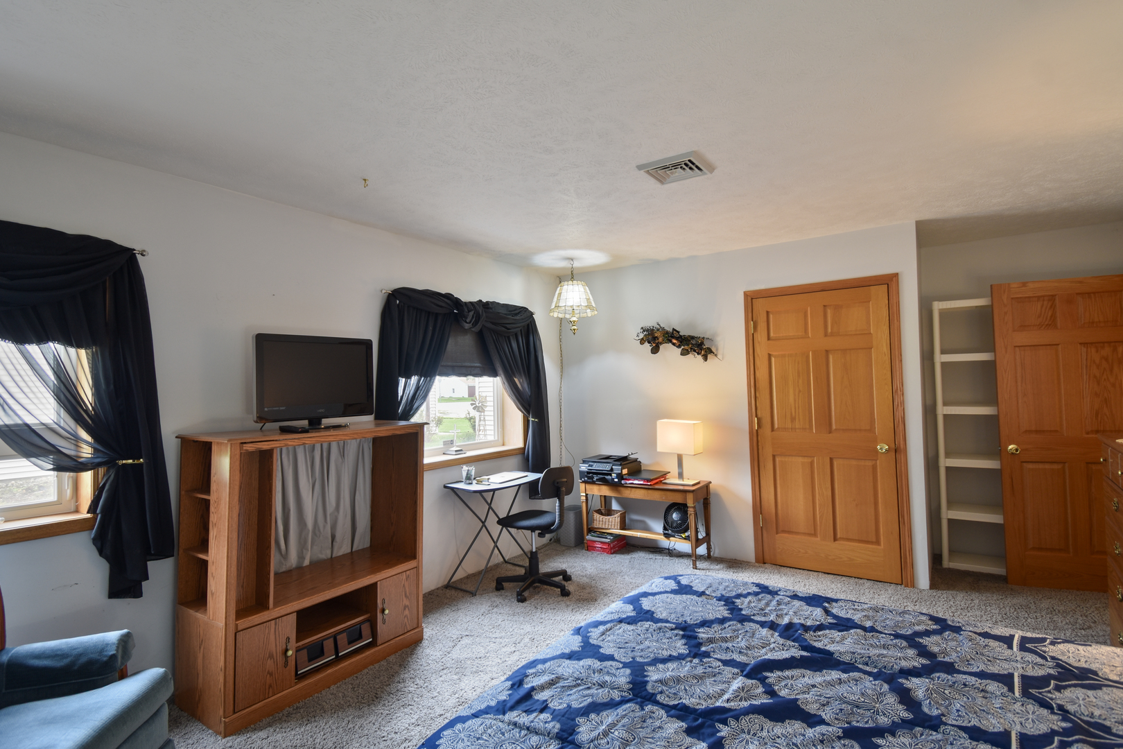 103 South 4th Street Chatsworth, IL 60921 - Photo 45 of 70 a living room with furniture a flat screen tv and a refrigerator