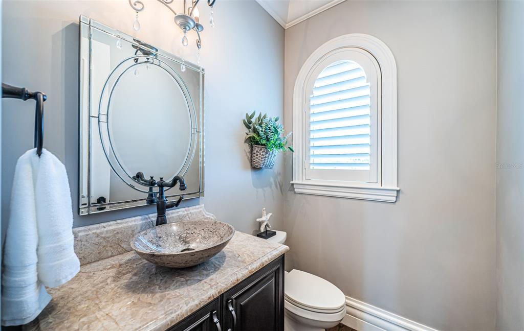 17824 Lee Avenue Redington Shores, FL 33708 - Photo 15 of 98 a bathroom with a granite countertop toilet a mirror and vanity