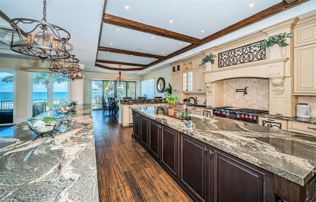17824 Lee Avenue Redington Shores, FL 33708 - Photo 16 of 98 a large kitchen with stainless steel appliances granite countertop a lot of counter space and a dining table