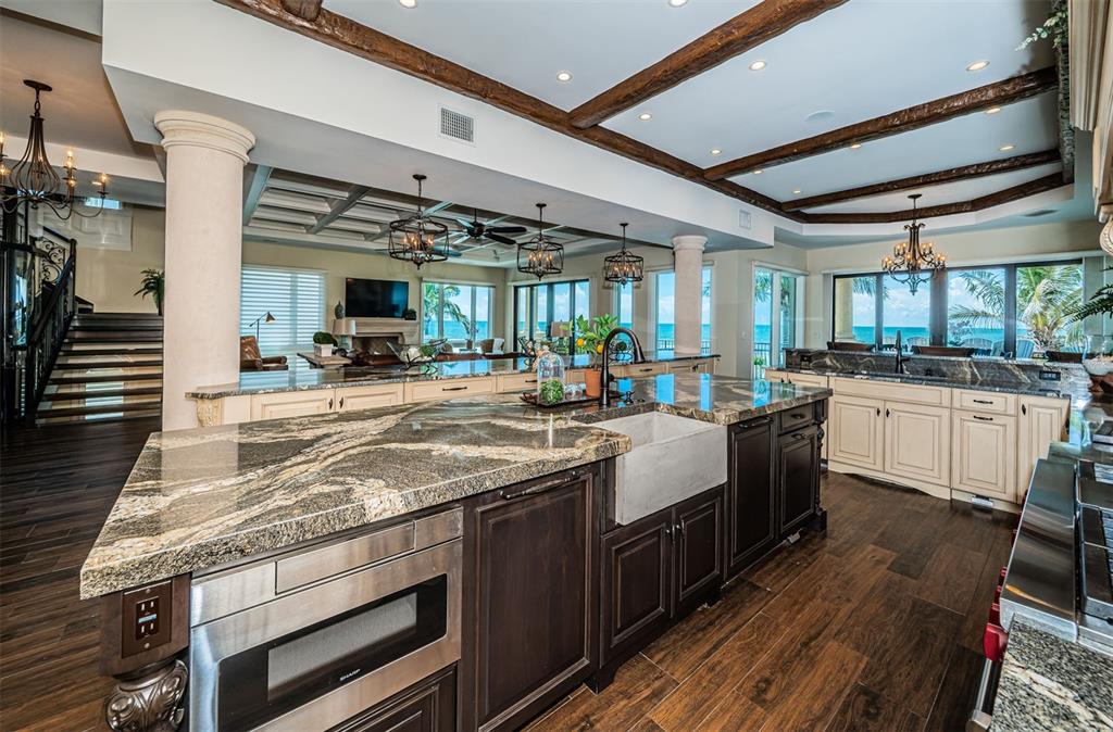 17824 Lee Avenue Redington Shores, FL 33708 - Photo 23 of 98 a kitchen with stainless steel appliances granite countertop a sink stove and wooden cabinets