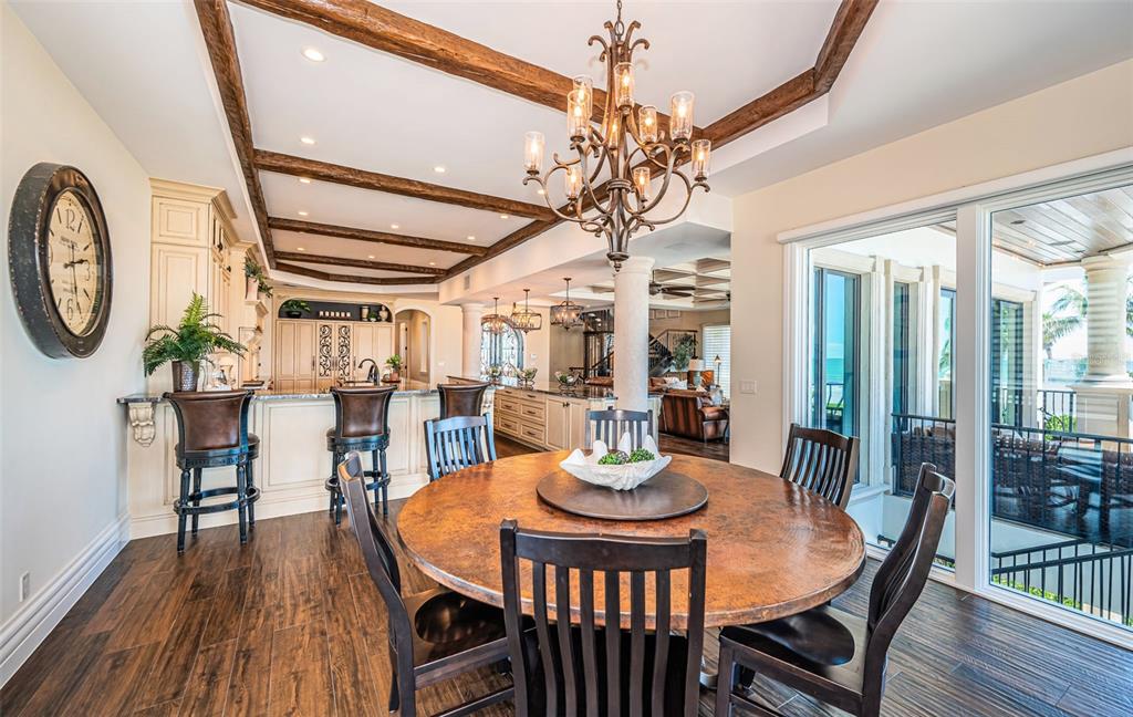 17824 Lee Avenue Redington Shores, FL 33708 - Photo 28 of 98 a dining room with furniture a chandelier and wooden floor