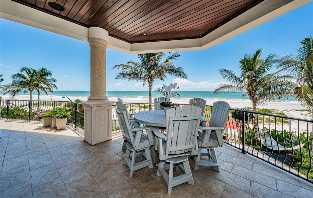 17824 Lee Avenue Redington Shores, FL 33708 - Photo 3 of 98 a dinning table and chairs in patio of a house