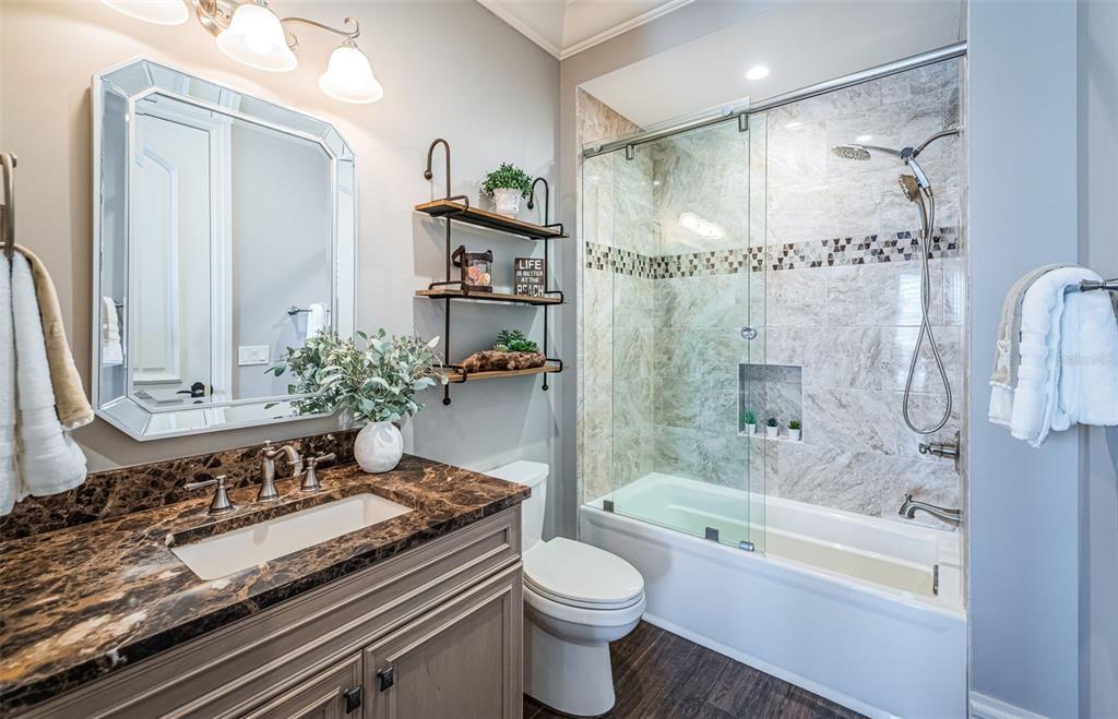 17824 Lee Avenue Redington Shores, FL 33708 - Photo 45 of 98 a bathroom with a granite countertop sink a toilet and shower