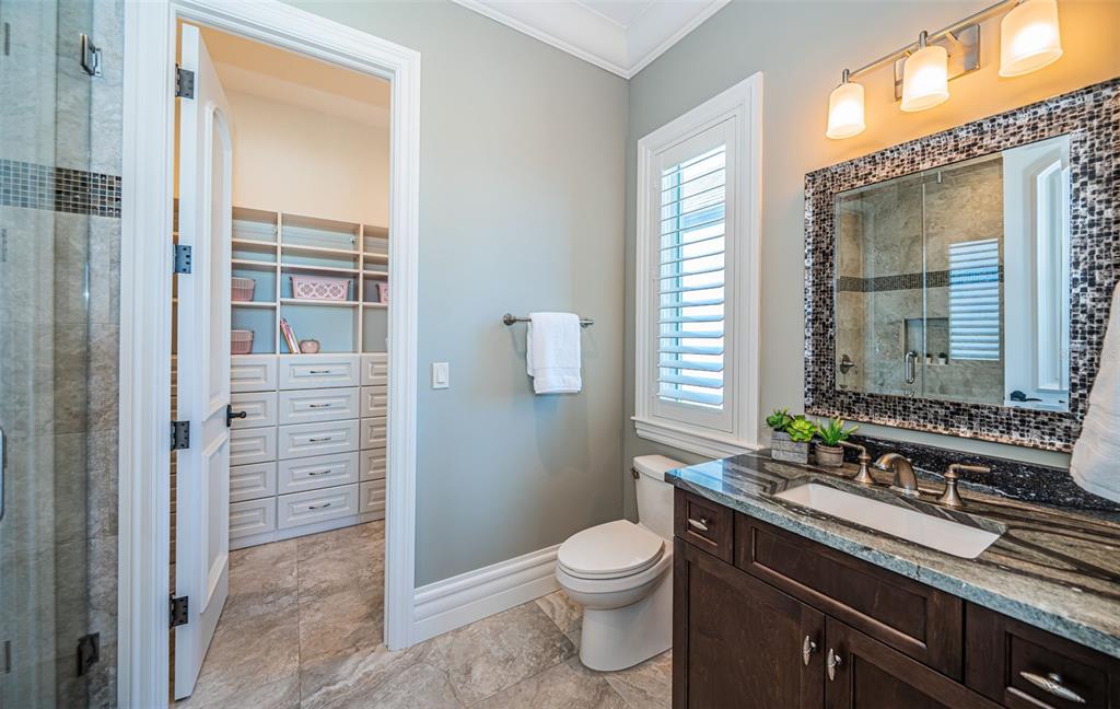 17824 Lee Avenue Redington Shores, FL 33708 - Photo 70 of 98 a bathroom with a granite countertop sink a toilet and shower