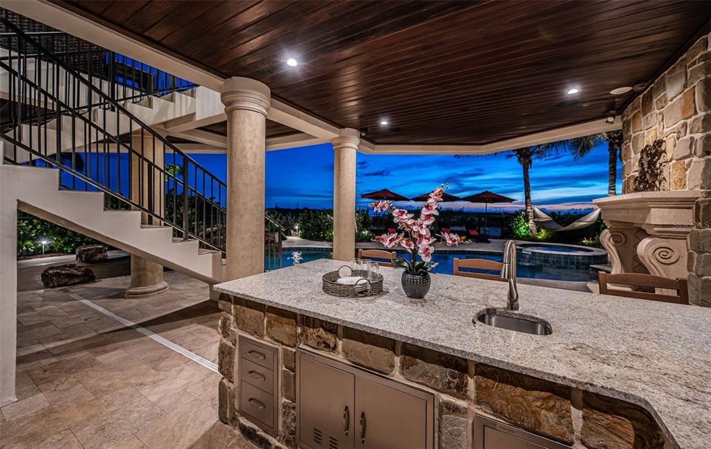 17824 Lee Avenue Redington Shores, FL 33708 - Photo 85 of 98 a kitchen with stainless steel appliances granite countertop a sink a stove and a wooden cabinets
