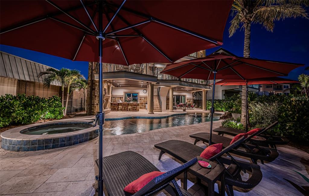17824 Lee Avenue Redington Shores, FL 33708 - Photo 90 of 98 a view of a backyard with table and chairs under an umbrella