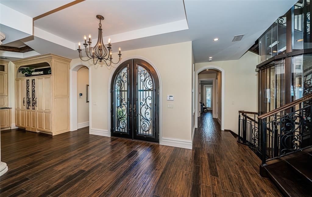 17824 Lee Avenue Redington Shores, FL 33708 - Photo 9 of 98 a view of a hallway with wooden floor and a chandelier