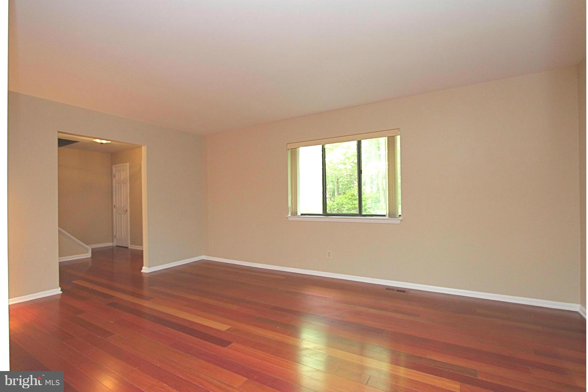 36 Constantine Drive Phoenix, MD 21131 - Photo 4 of 30 an empty room with wooden floor and windows