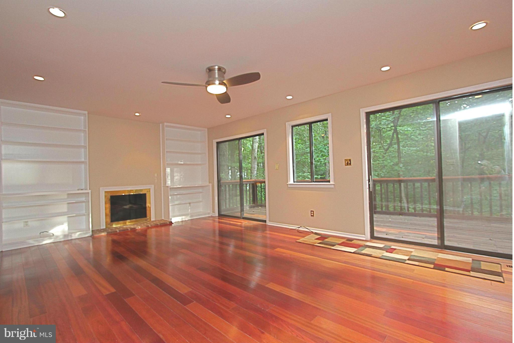 36 Constantine Drive Phoenix, MD 21131 - Photo 6 of 30 a view of a livingroom with wooden floor a fireplace and window