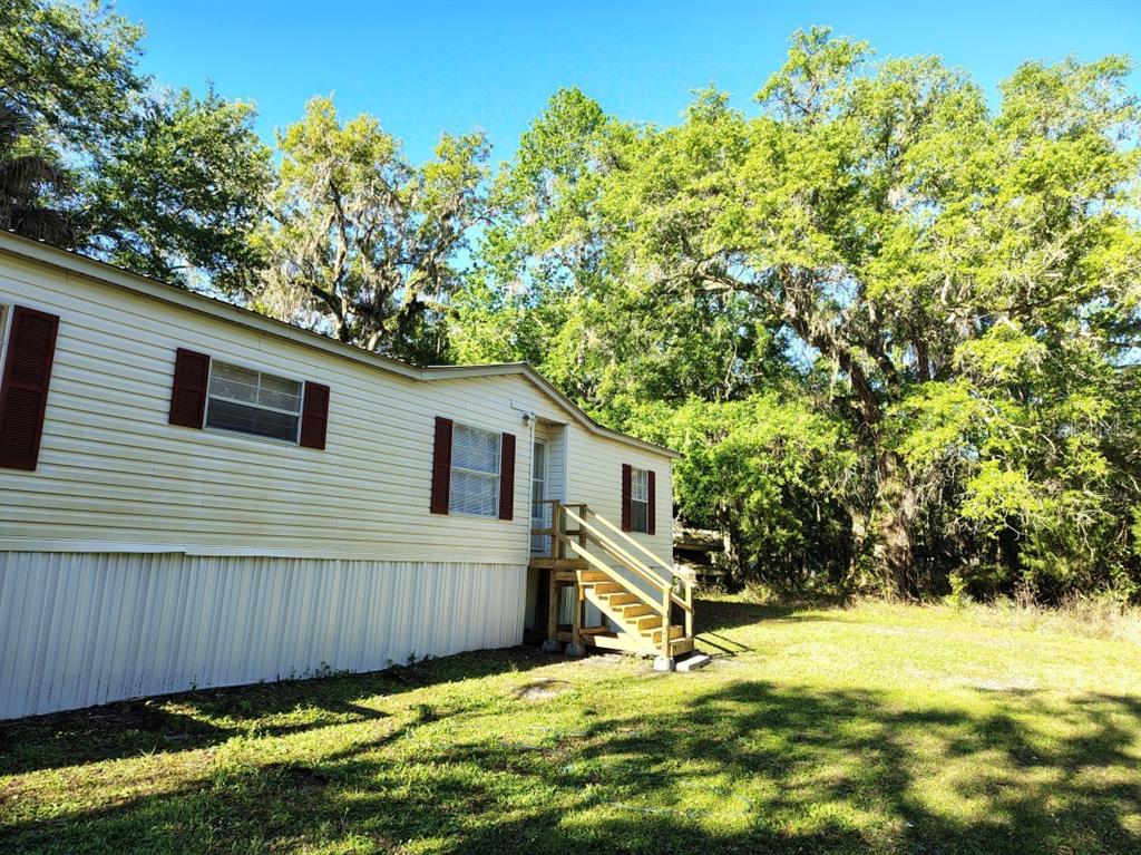 3440 County Road 656 Webster, FL 33597 - Photo 14 of 14 a view of a backyard with plants and large tree
