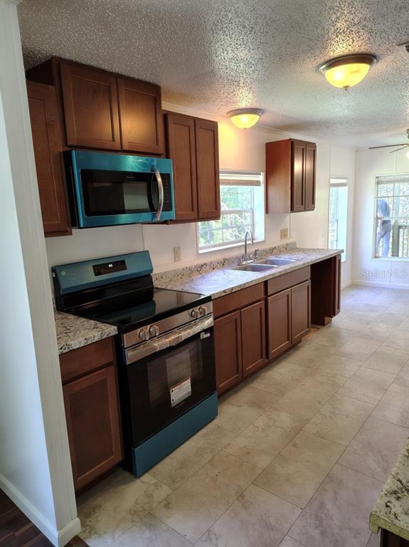 3440 County Road 656 Webster, FL 33597 - Photo 2 of 14 a kitchen with stainless steel appliances granite countertop a sink and a stove