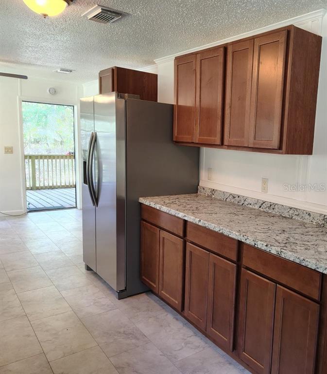 3440 County Road 656 Webster, FL 33597 - Photo 6 of 14 a kitchen with stainless steel appliances granite countertop a refrigerator and a sink