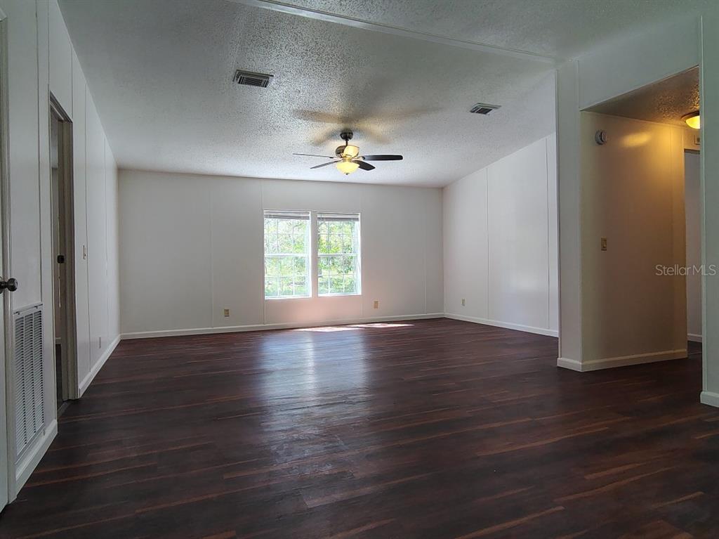 3440 County Road 656 Webster, FL 33597 - Photo 8 of 14 an empty room with wooden floor and windows