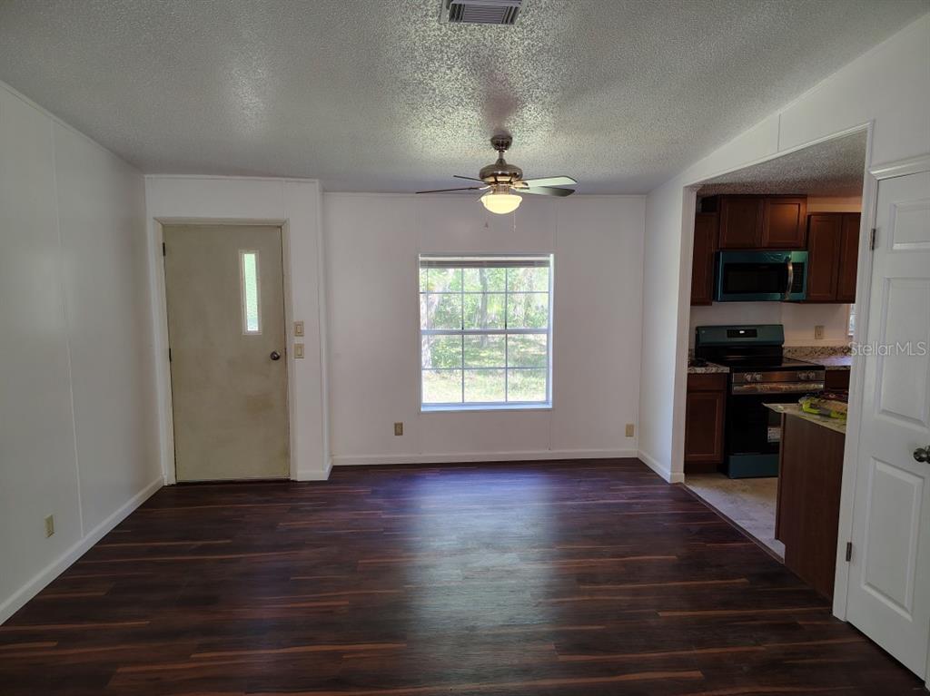 3440 County Road 656 Webster, FL 33597 - Photo 9 of 14 wooden floor in an empty room with a window