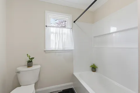 a white bath tub sitting next to a white toilet