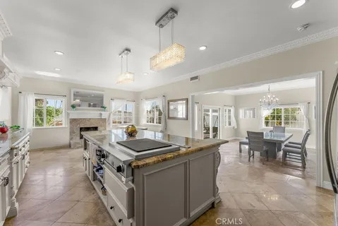 a view of a dining room with furniture a chandelier and wooden floor